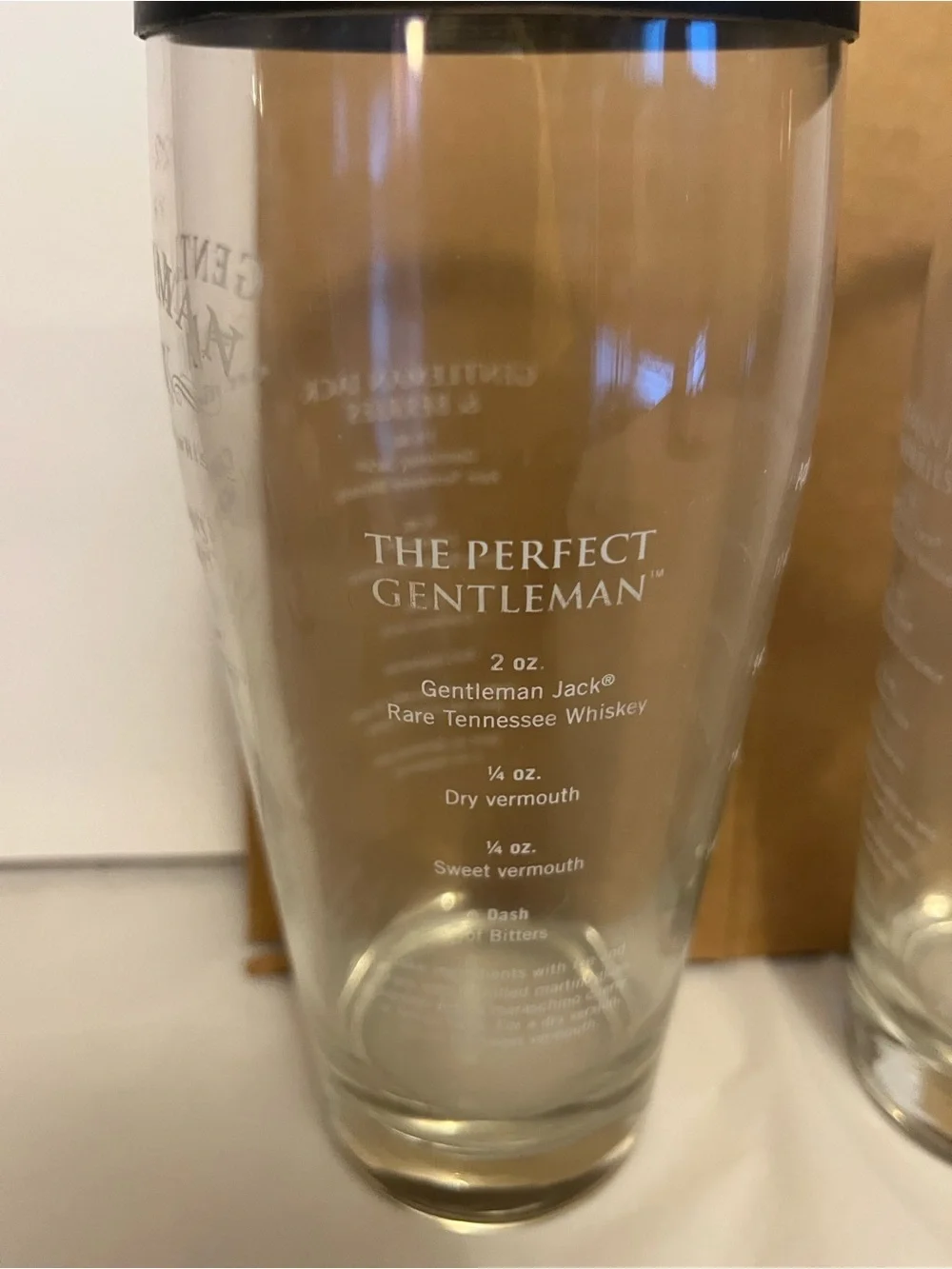 2,Gentleman Jack brand glass cocktail shaker with a recipe printed on the side.